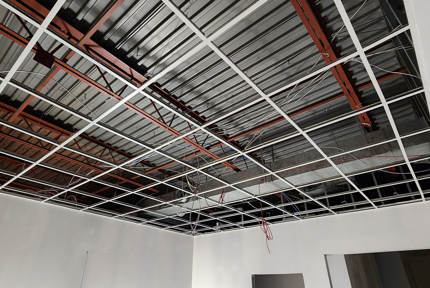 Suspended ceiling grid and exposed wiring at Royal Windsor Pharmacy in Mississauga